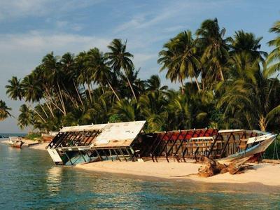 A boat wreckage by the beach at Derawan Islands