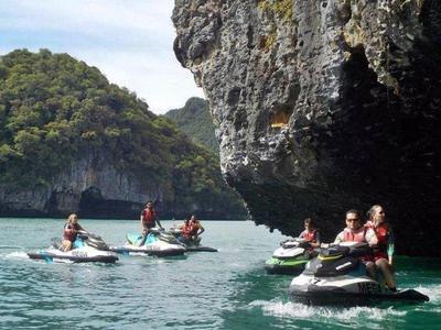 A group of tourists jetski near a cliff rock at Langkawi Islands