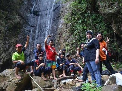 A group posing for picture at a waterfall in Endau Rompin National Park