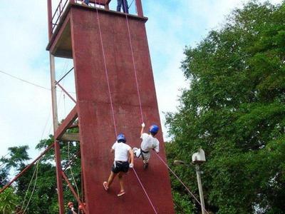 Abseiling down a tall wall at Jeram Besu