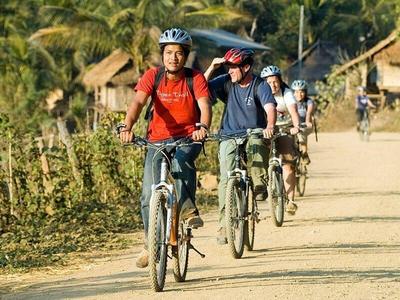 Cycling tourists in Luang Prabang guided by a local
