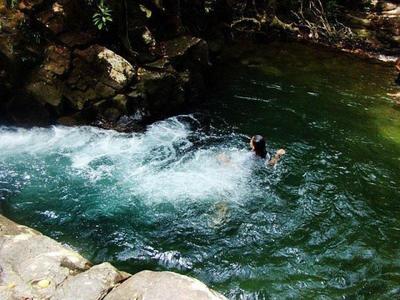 Girl swimming in a natural pool in Langkawi