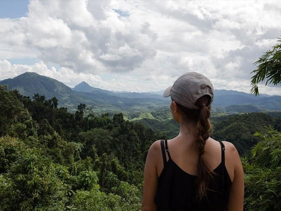 Lady looking at the landscape of forest in Laos