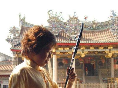 Lady performing with cultural music equipment in Georgetown