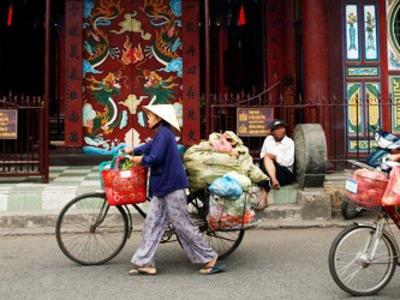 locals cycling to temple in Hoi an