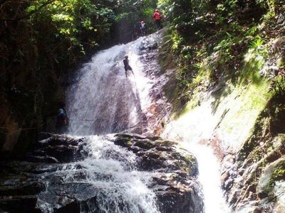 Man abseiling down a big waterfall in Gopeng