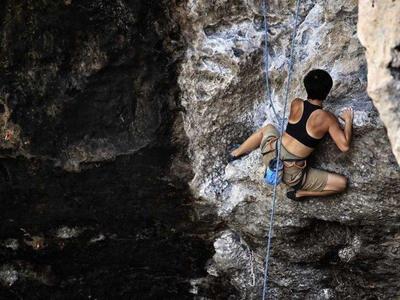 Man climbing up the rocks in Krabi Island