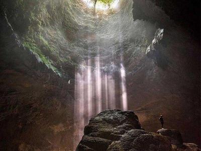 Man exploring in the Jomblang Cave