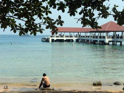 Man resting by the beach of Bidong Island