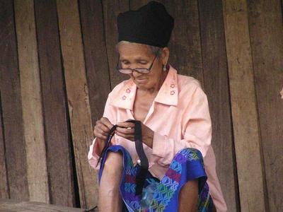Old lady weaving at a village in Laos
