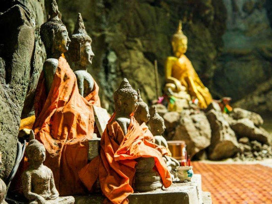 Pak Ou Caves Buddha statues with robes