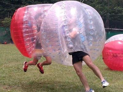 Players jumping into each other in bubble ball at Ola Park