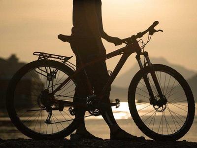 Tourist carrying a mountain bike in Laos
