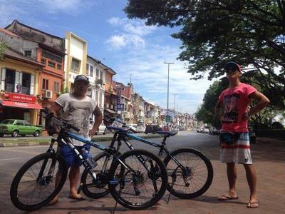 Tourist standing beside their bicycles in Kuching