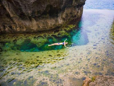 Tourist swimming in the waters of Nusa Penida