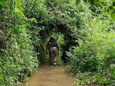 Tourist trekking over streams in Laos
