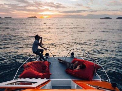 Tourists chilling at the deck area of sunset cruise in Kota Kinabalu