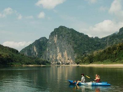 Tourists kayak at Nam Khan Valley