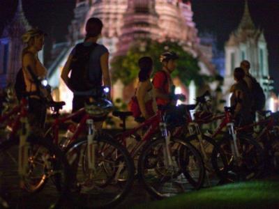 Tourists on night cycling tour at Bangkok