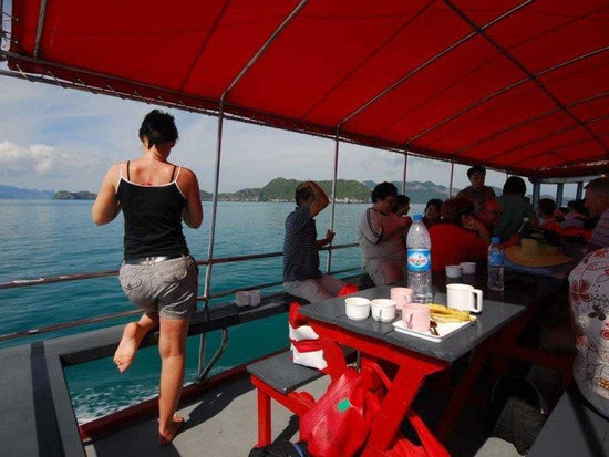 Tourists resting a the top deck of a boat in Angthong Marine Park