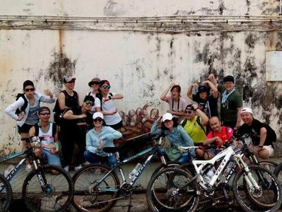 Tourists taking a picture with street art in Kuching