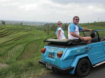 Two tourists on the Volkswagen Safari ride at rice terraces in Bali