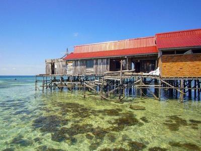 Village houses built on the shore of Mabul Island