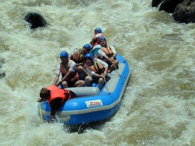 Visitors gripping themselves in the rapids of Jeram Besu