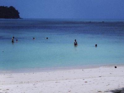 Visitors swimming near the shores at Monkey Beach