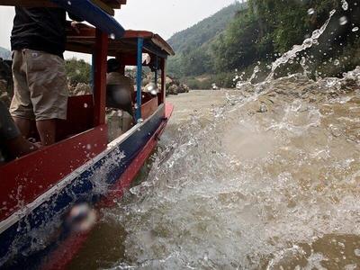Water splashing around the boat on river